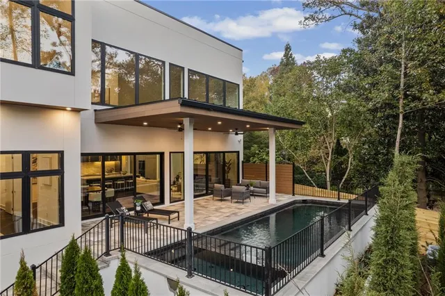 a view of a patio with table and chairs with wooden floor and fence