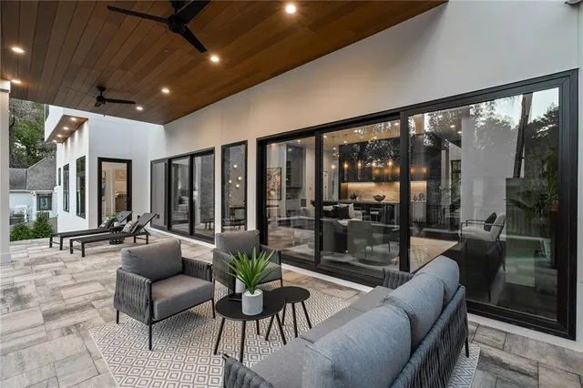 a living room with furniture and a floor to ceiling window