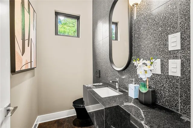 a bathroom with a sink mirror and vanity
