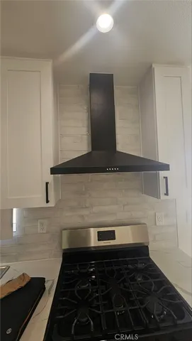 a view of a hallway with wooden floor and entryway