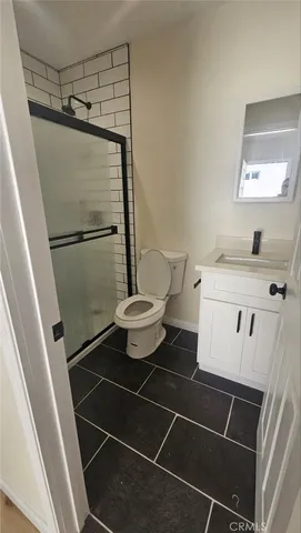 a kitchen with a refrigerator and a stove top oven