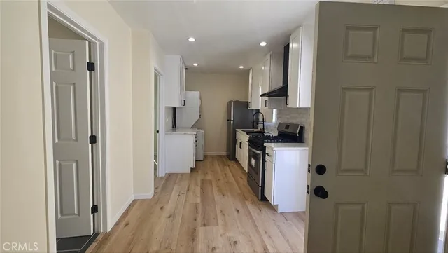 a stove top oven sitting inside of a kitchen