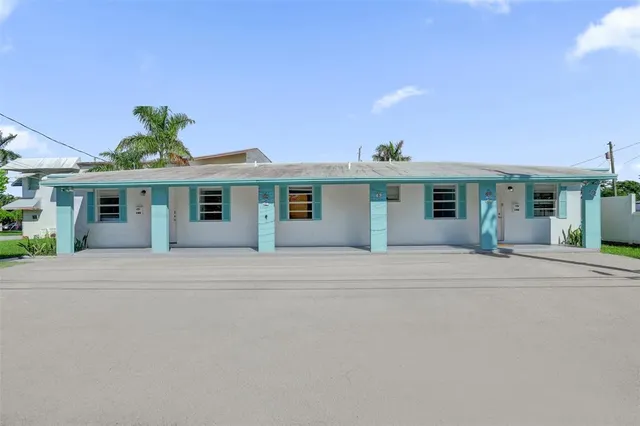 a front view of a house with a garden and plants