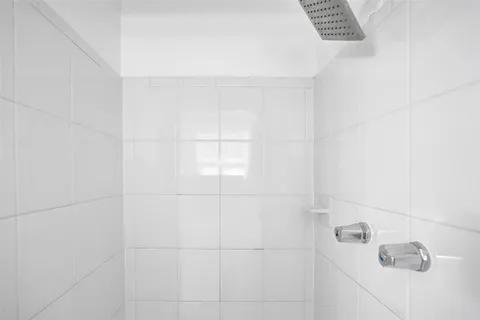 a bathroom with a granite countertop sink toilet a large mirror and a window