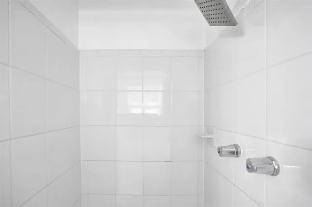 a bathroom with a granite countertop sink toilet a large mirror and a window