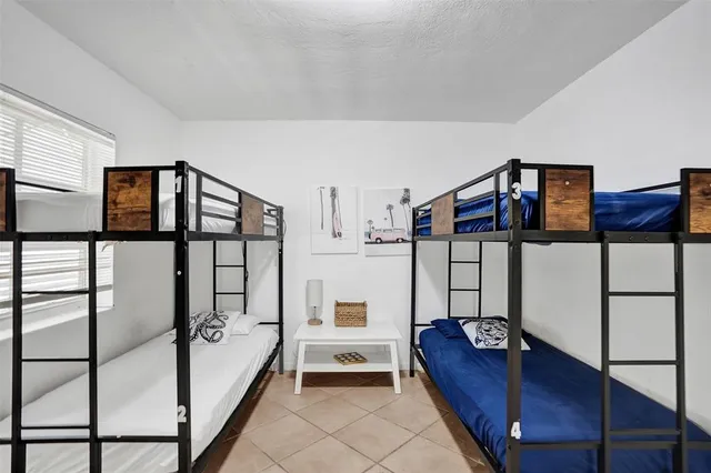 a spacious bedroom with a bed and a window