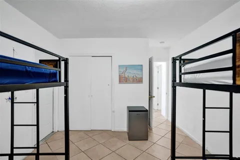 a bedroom with a bed and large window