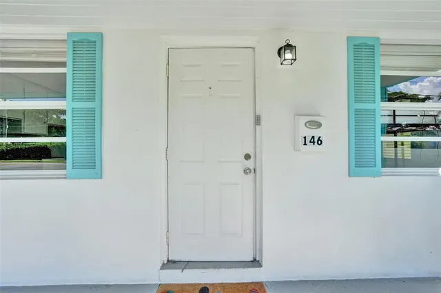 a kitchen with stainless steel appliances granite countertop white cabinets a window and a sink