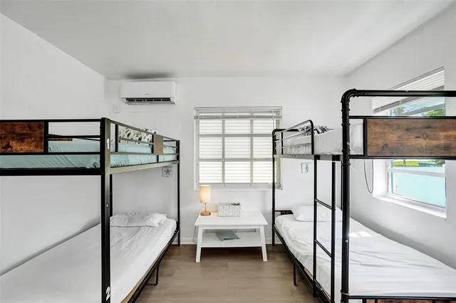 a kitchen with a refrigerator and white cabinets