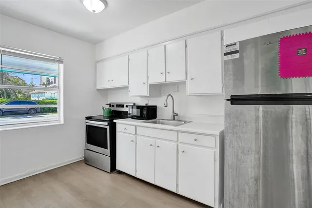 a bathroom with a granite countertop sink mirror vanity and toilet