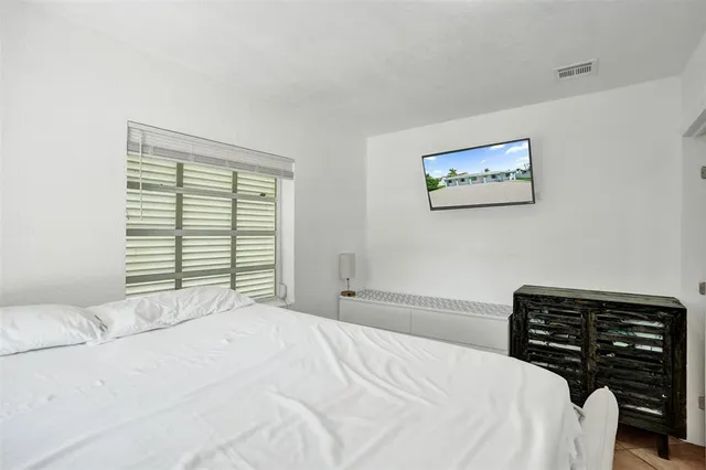 a bedroom with a bed and a desk