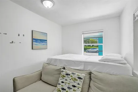 a living room with a couch and a potted plant