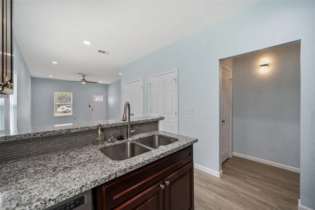 a kitchen with stainless steel appliances granite countertop a sink and cabinets