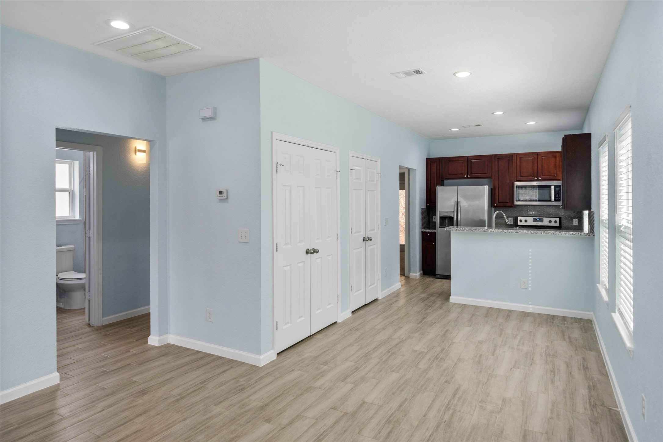 241 Ridgeside Court Montgomery, TX 77316 - Photo 14 of 30 a view of a kitchen with a refrigerator a microwave and a sink