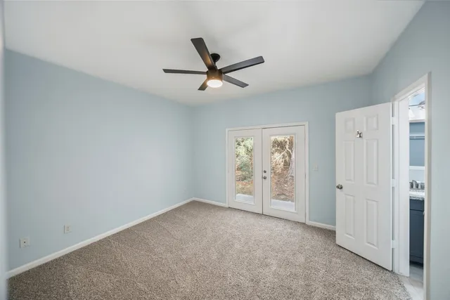 an empty room with closet and windows