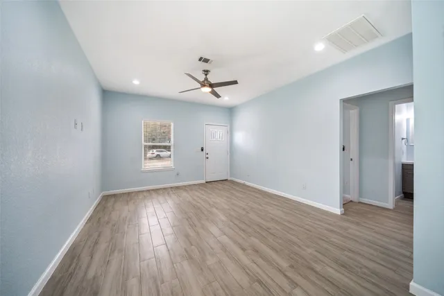 wooden floor in an empty room with a window