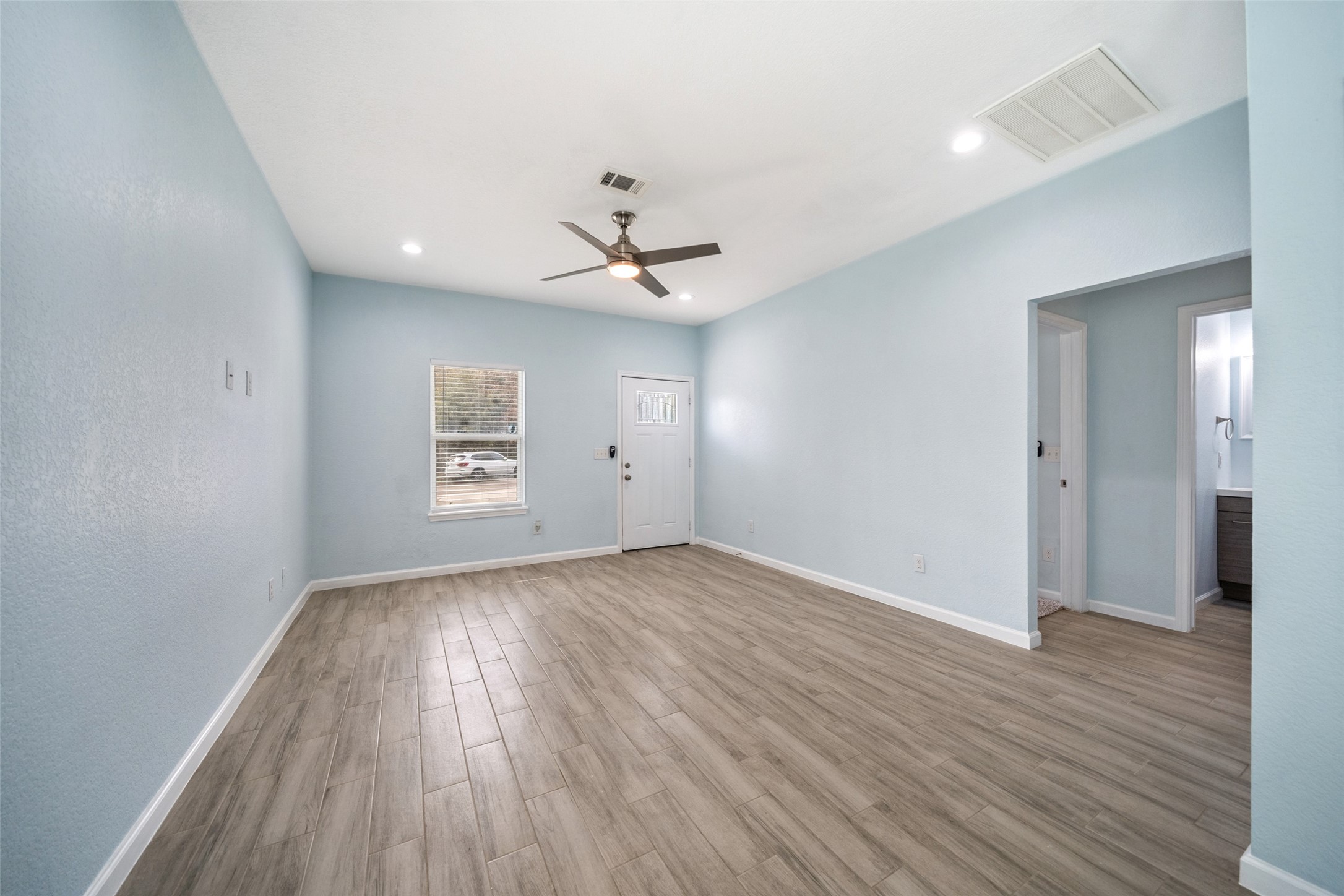 241 Ridgeside Court Montgomery, TX 77316 - Photo 4 of 30 wooden floor in an empty room with a window