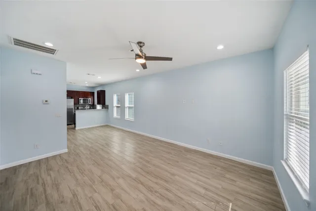wooden floor in an empty room with a window