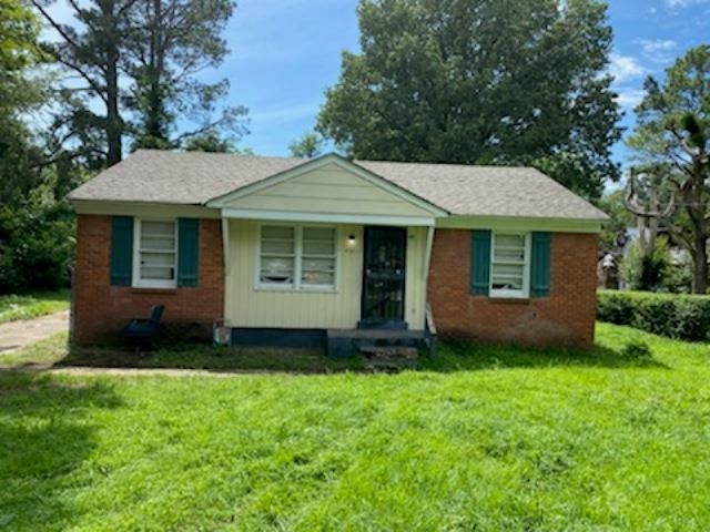 4901 Fairley Road Memphis, TN 38109 - Photo 1 of 1 a front view of a house with a garden and yard
