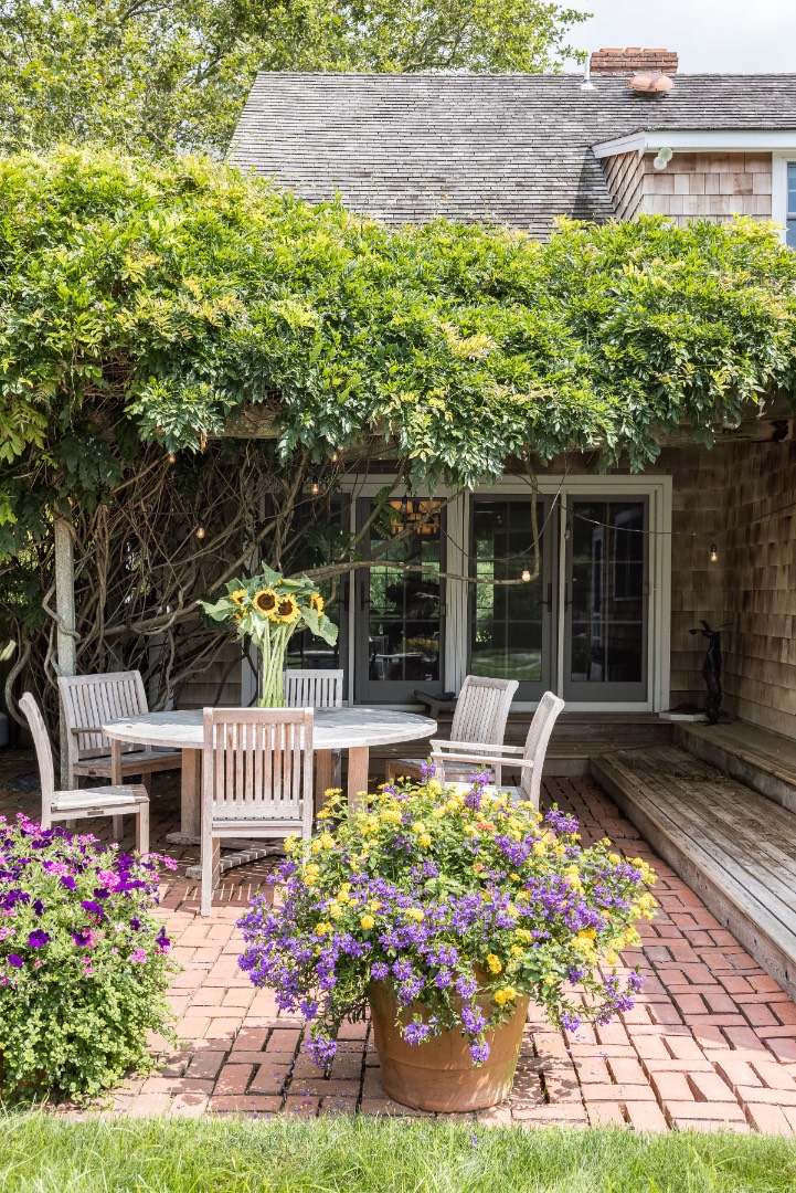 227 Sagaponack Road Bridgehampton, NY 11932 - Photo 11 of 26 a front view of a house with a garden