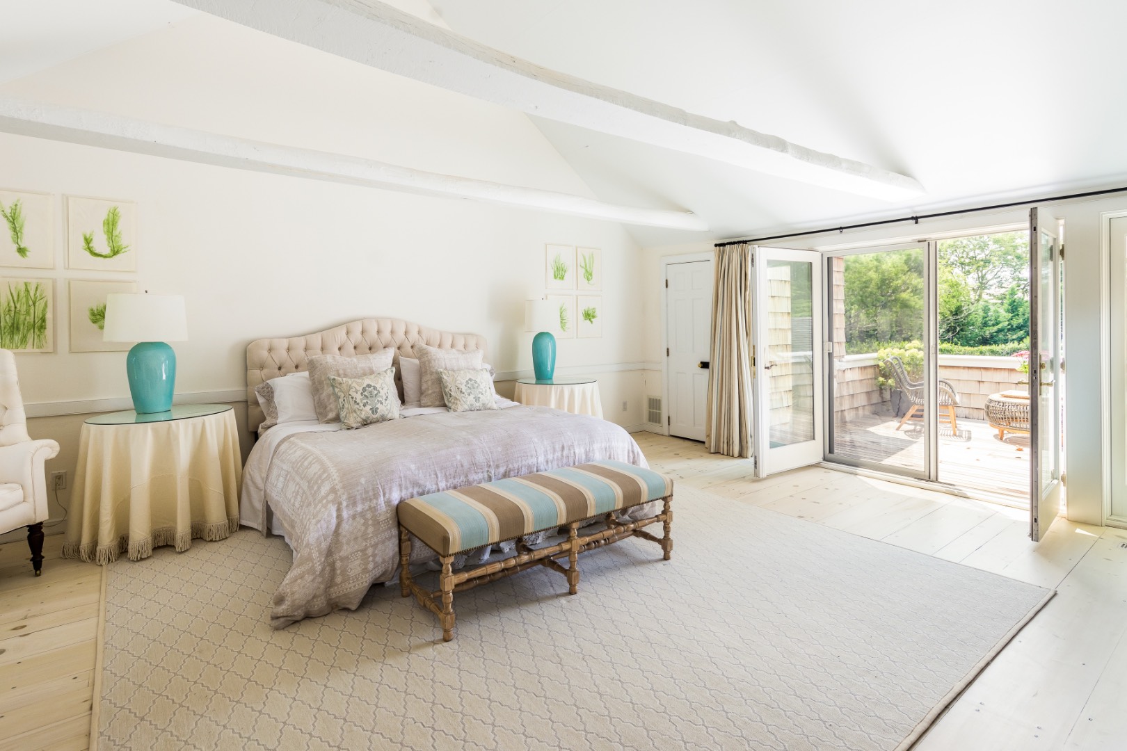 227 Sagaponack Road Bridgehampton, NY 11932 - Photo 19 of 26 a spacious bedroom with a bed and large window