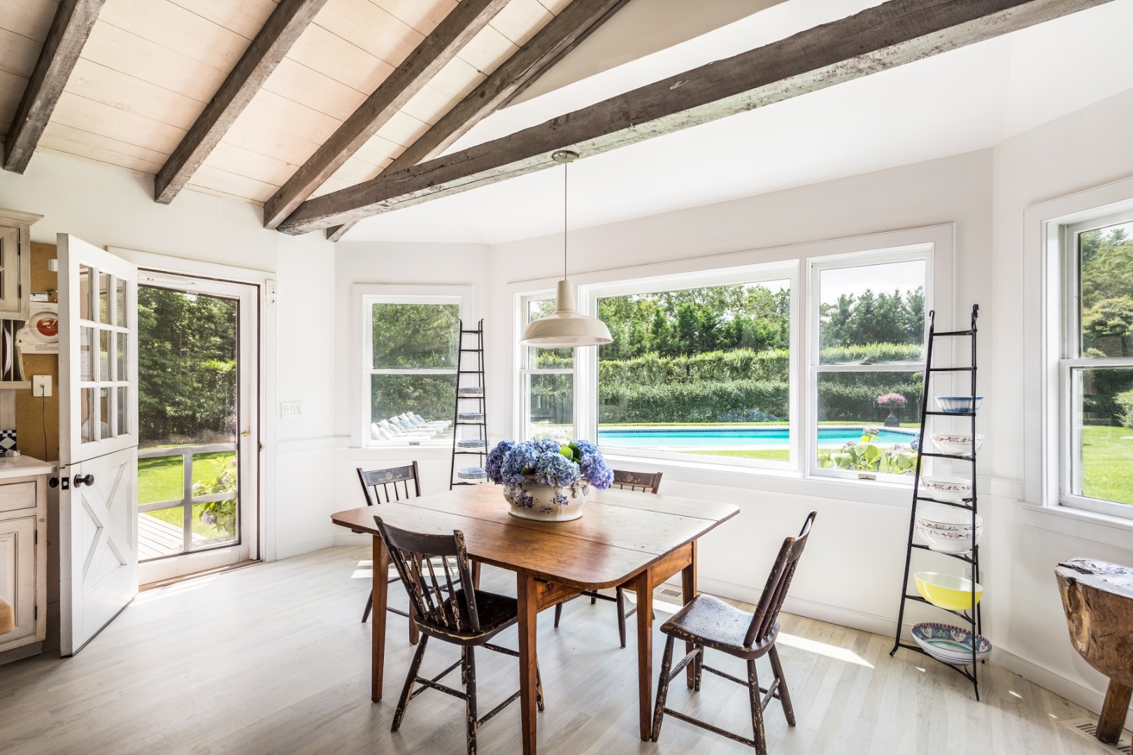 227 Sagaponack Road Bridgehampton, NY 11932 - Photo 6 of 26 a view of a dining room with furniture large windows and wooden floor