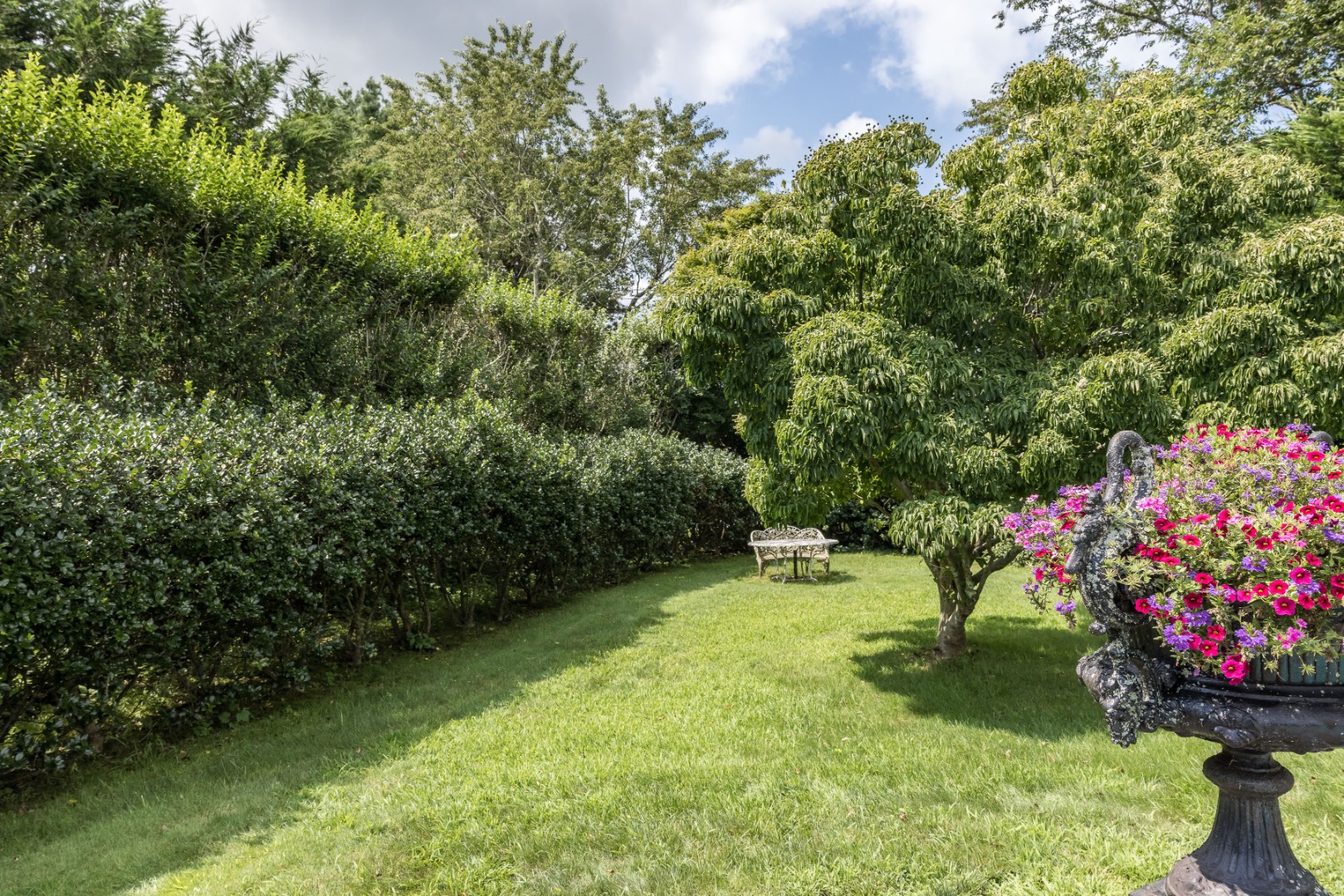 227 Sagaponack Road Bridgehampton, NY 11932 - Photo 10 of 26 a view of a backyard with plants and a fountain