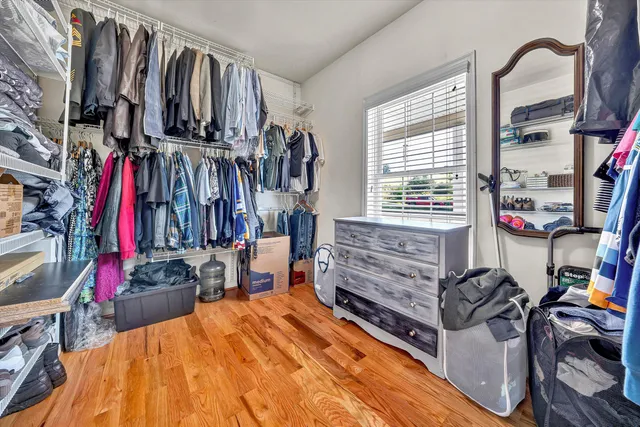 a view of walk in closet with clothes and shoes