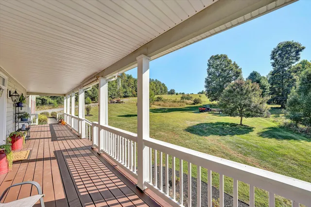 a view of balcony with wooden floor and outdoor seating
