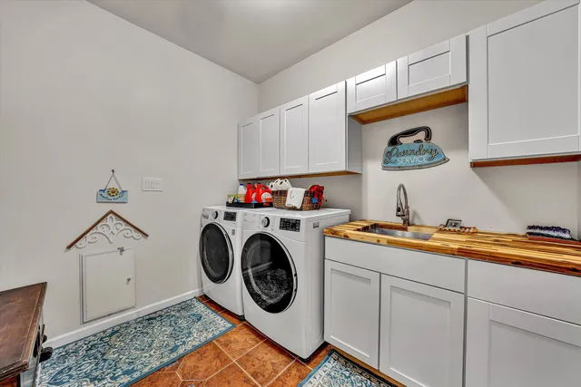 a utility room with sink dryer and washer