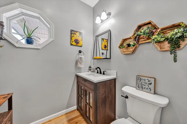 a bathroom with a toilet a sink and a mirror