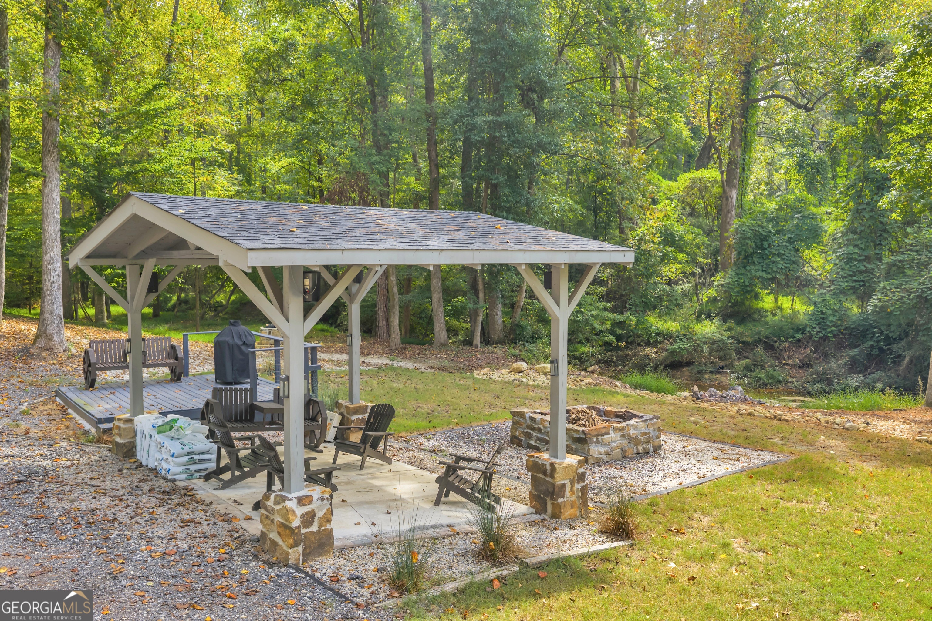 1542 Silver Hill Road Stone Mountain, GA 30087 - Photo 15 of 40 a view of a patio with table and chairs under an umbrella