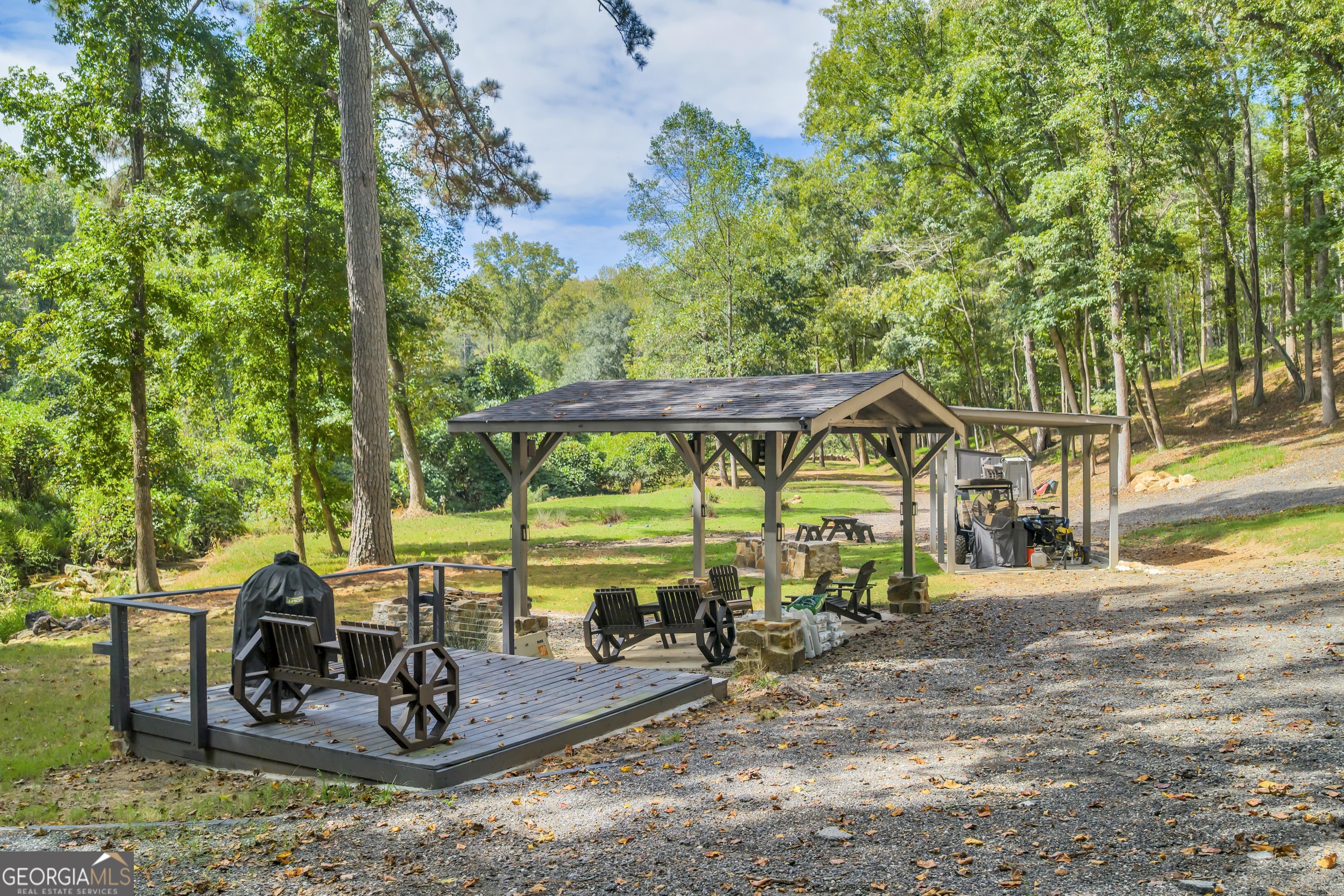 1542 Silver Hill Road Stone Mountain, GA 30087 - Photo 18 of 40 a view of a wooden house with a yard and furniture