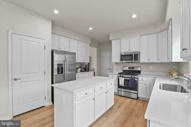 a view of kitchen with refrigerator dining table and chairs