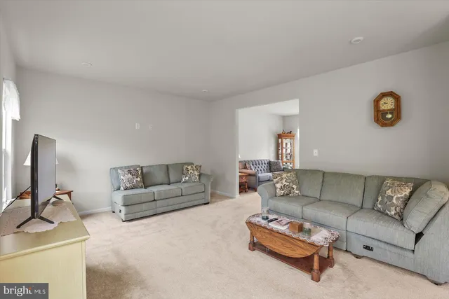 a living room with furniture a lamp and a window