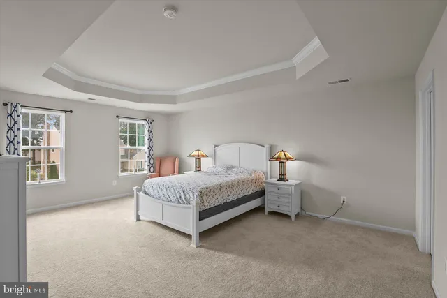 a bedroom with a bed and a dresser in it