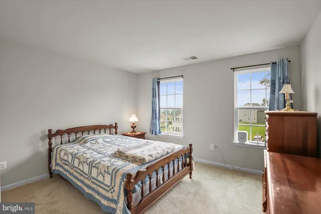 a bedroom with a bed and a dresser in it