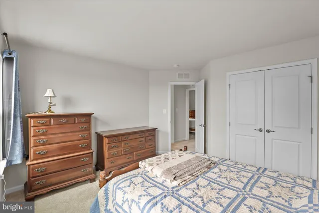 a view of a hallway with furniture window and wooden floor