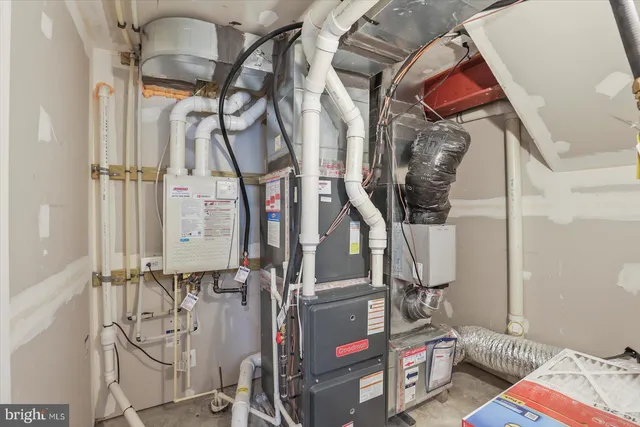 a front view of a house with a big yard and potted plants