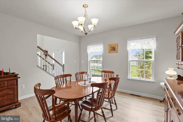a kitchen with a table chairs refrigerator and cabinets
