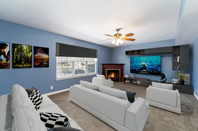 a living room with furniture a fireplace and a flat screen tv