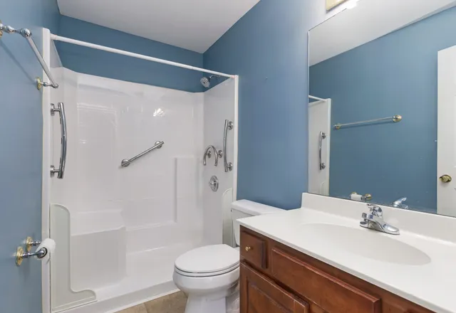 a bathroom with a sink toilet and shower