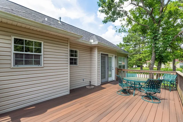 a view of a chairs and table on the deck