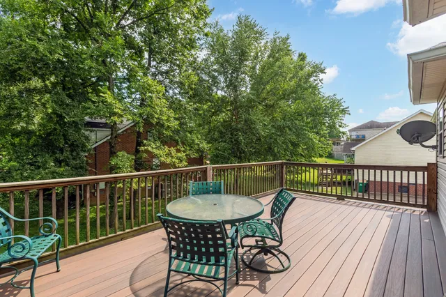 a view of a house with a yard balcony and a tree