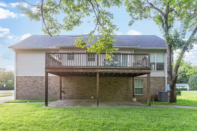 a view of a house with a yard and sitting area