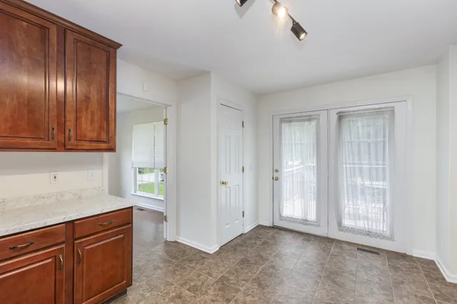 a view of an entryway with wooden floor