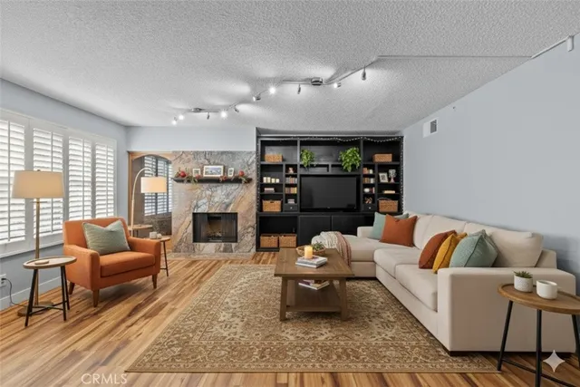 a living room with furniture fireplace and window