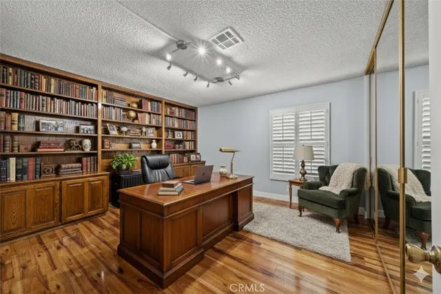 a living room with furniture a bookshelf and a window