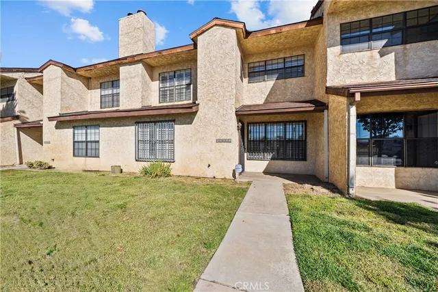 a front view of a house with a garden and plants