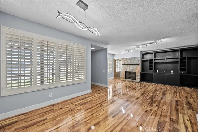 a large kitchen with kitchen island granite countertop a refrigerator and wooden floor